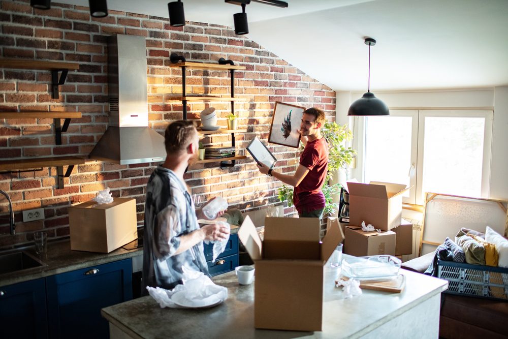 Young,Same,Sex,Male,Couple,Decorating,The,Walls,Of,A